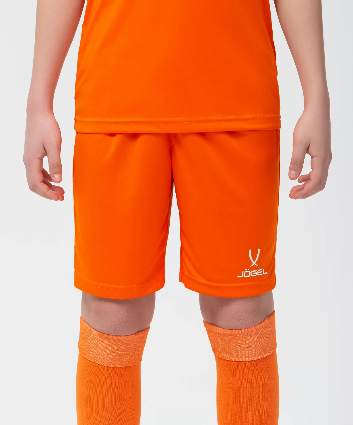Реальное фото Шорты игровые JÖGEL CAMP Classic Shorts, оранжевый/белый, детский от магазина Спортев